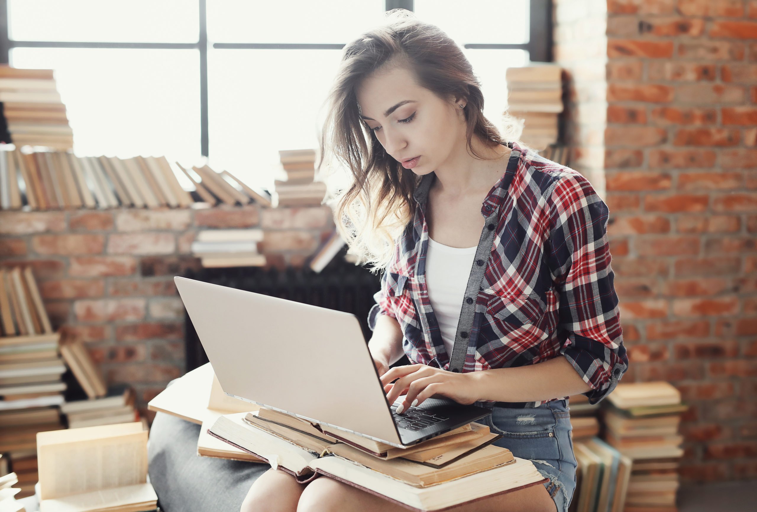 a woman sitting at a desk with a laptop