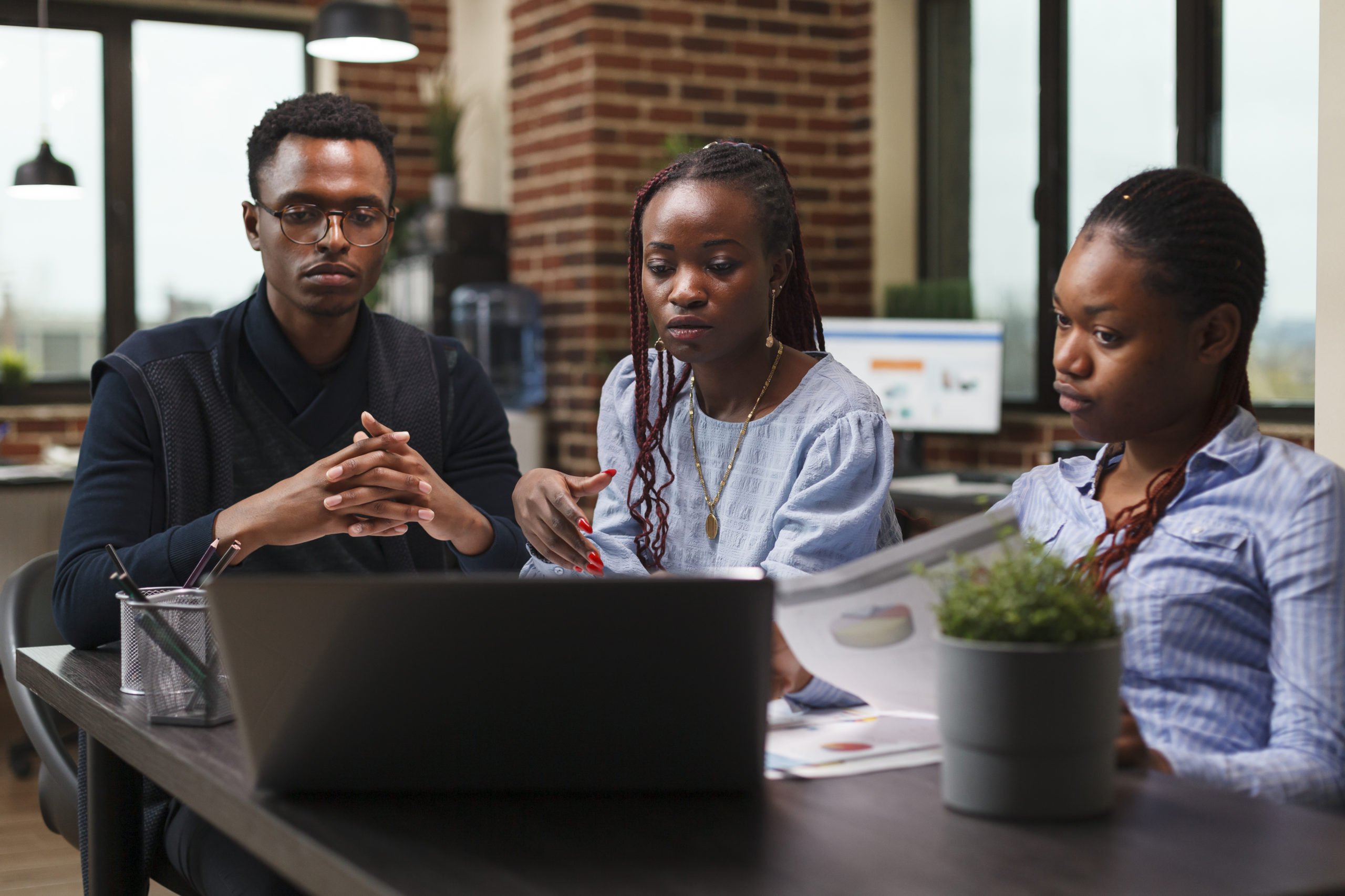 Accounting department office workers analyzing financial data charts on work laptop