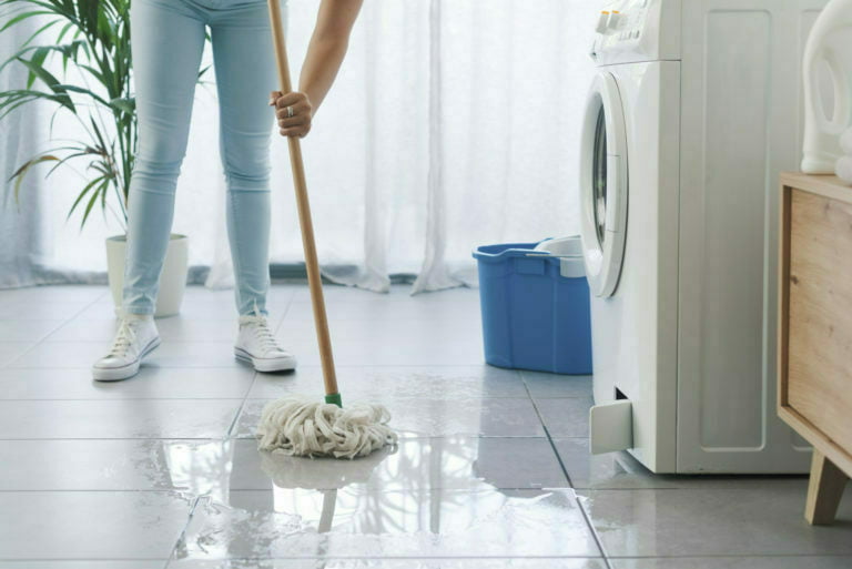 Broken washing machine leaking on the floor